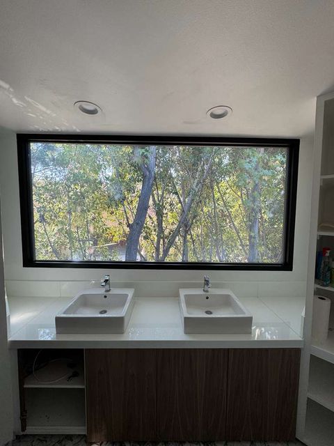 Clear-mode switchable smart film on an LA residential bathroom window during install reference walkthrough