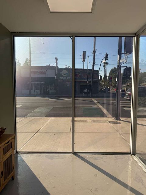 Switchable PDLC smart film on a commercial storefront glass front showing clear-mode visibility during business hours