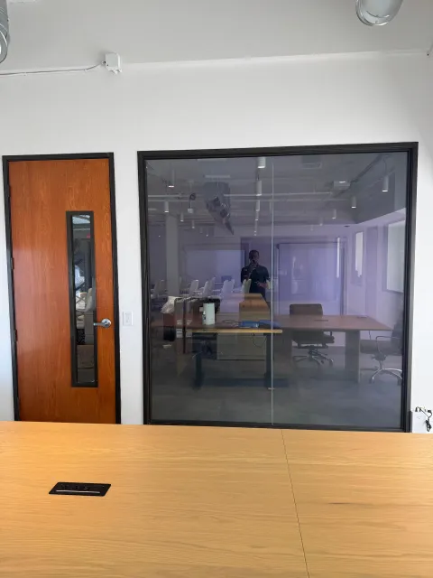 Switchable smart glass conference room wall in clear mode at office in Newport Beach CA