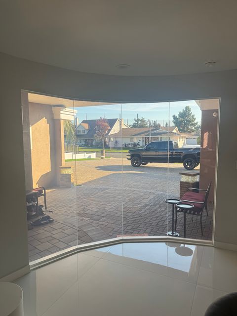 Floor-to-ceiling window in clear mode, full daylight through the glass