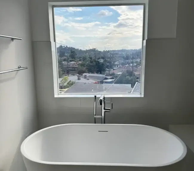 Modern bathroom with privacy-on-demand switchable film on a Los Angeles residential window