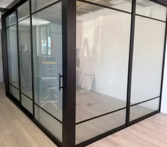 Modern office partition transitioning from frosted to clear under smart film application